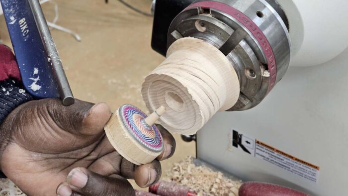 The top side of the top is being inserted into the recess Darryl just turned into the chuck.